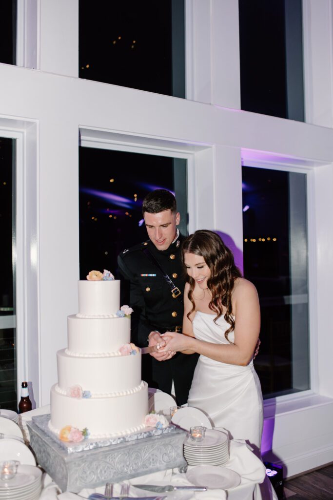 bride and groom cutting the cake during wedding reception