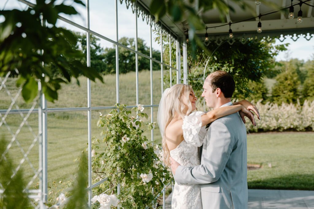 romantic bride and groom photos at terrain gardens for a garden wedding in the summer