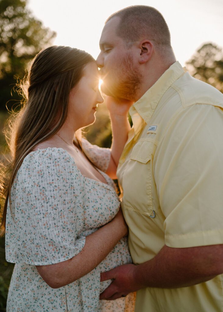 couple photos with baby bump honoring rainbow baby
