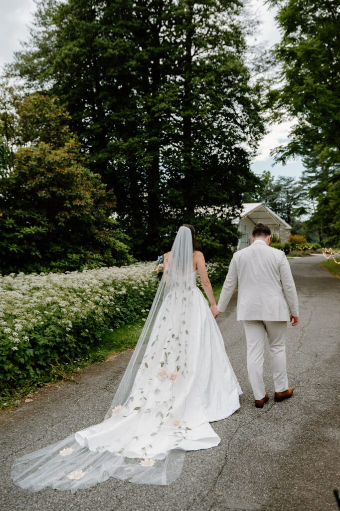 bride and groom holding hands and walking