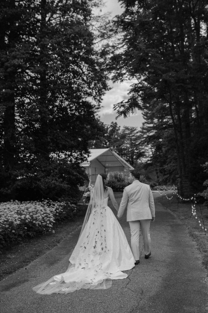 bride and groom holding hands and walking